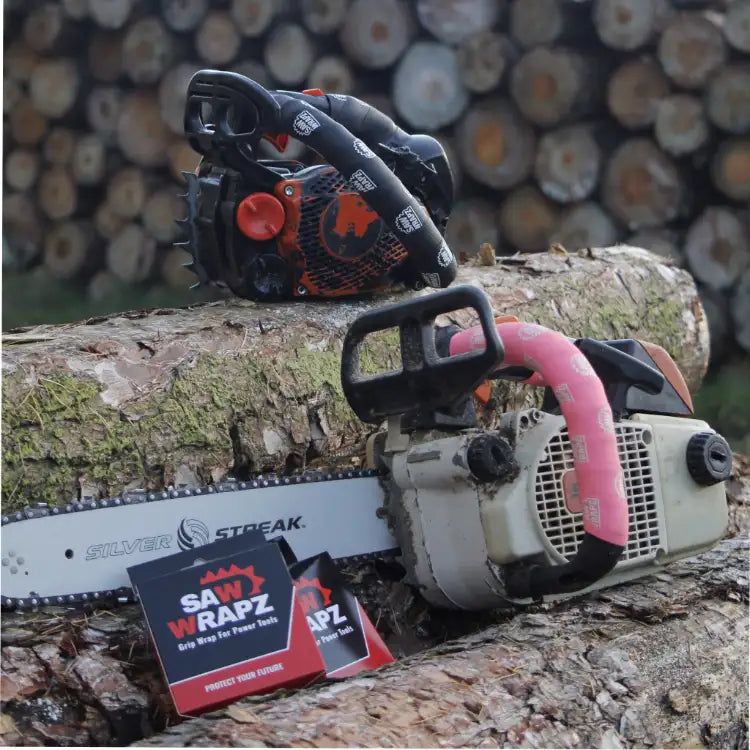 Black and orange chainsaw with a silver blade, resting on a log.