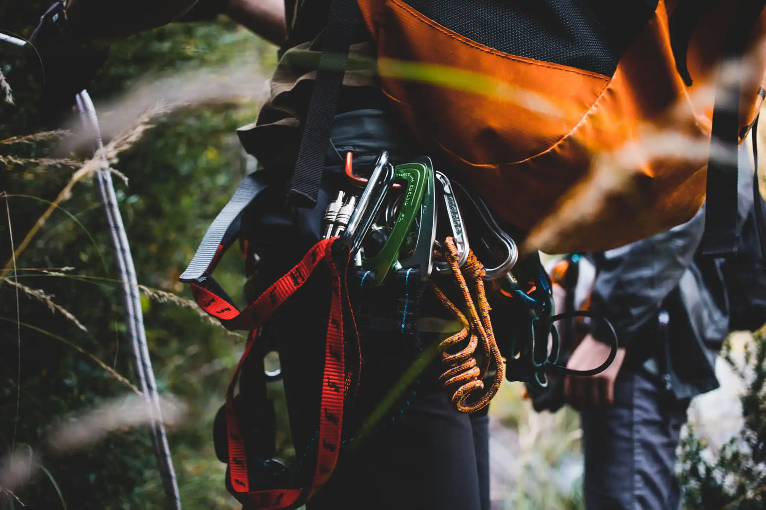 Climbing harness with attached carabiners and rope.