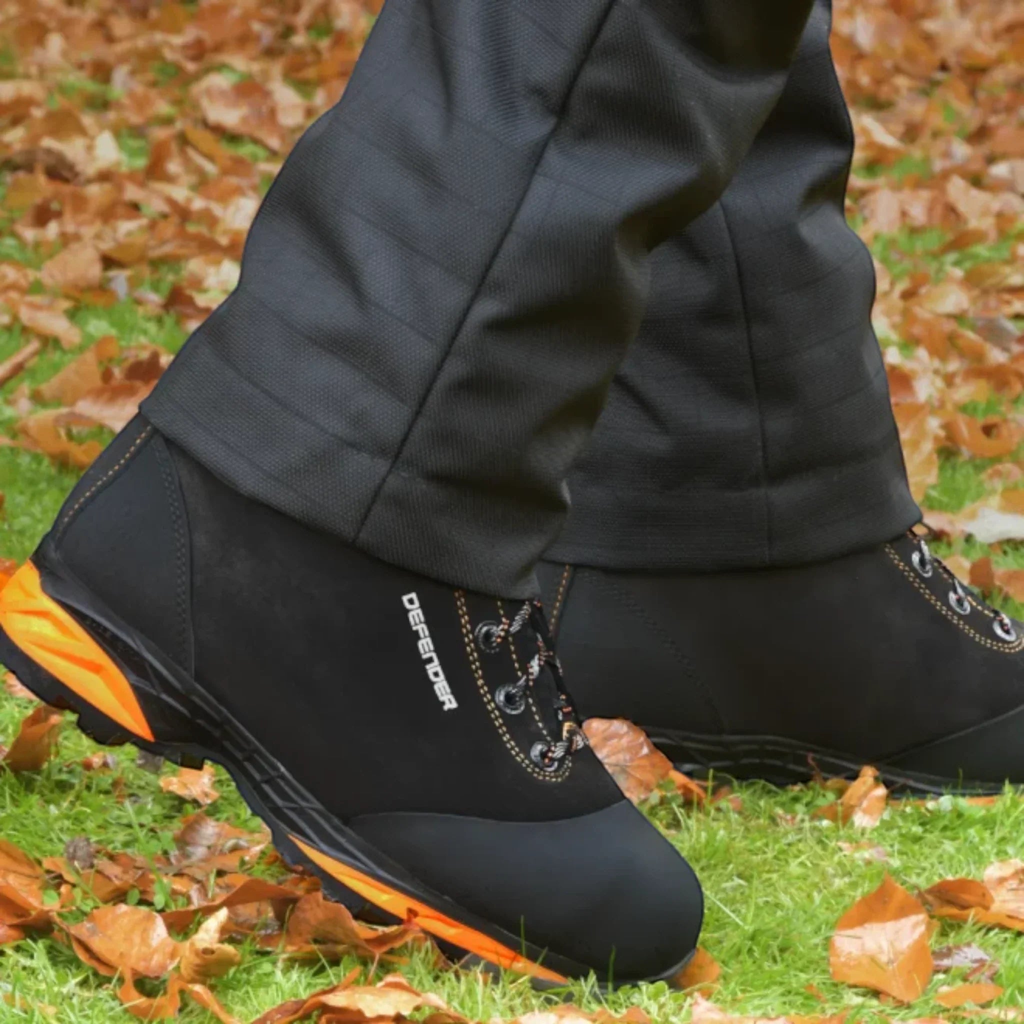 STEIN Defender V2 chainsaw boot in action – arborist wearing black safety boot in forestry environment

